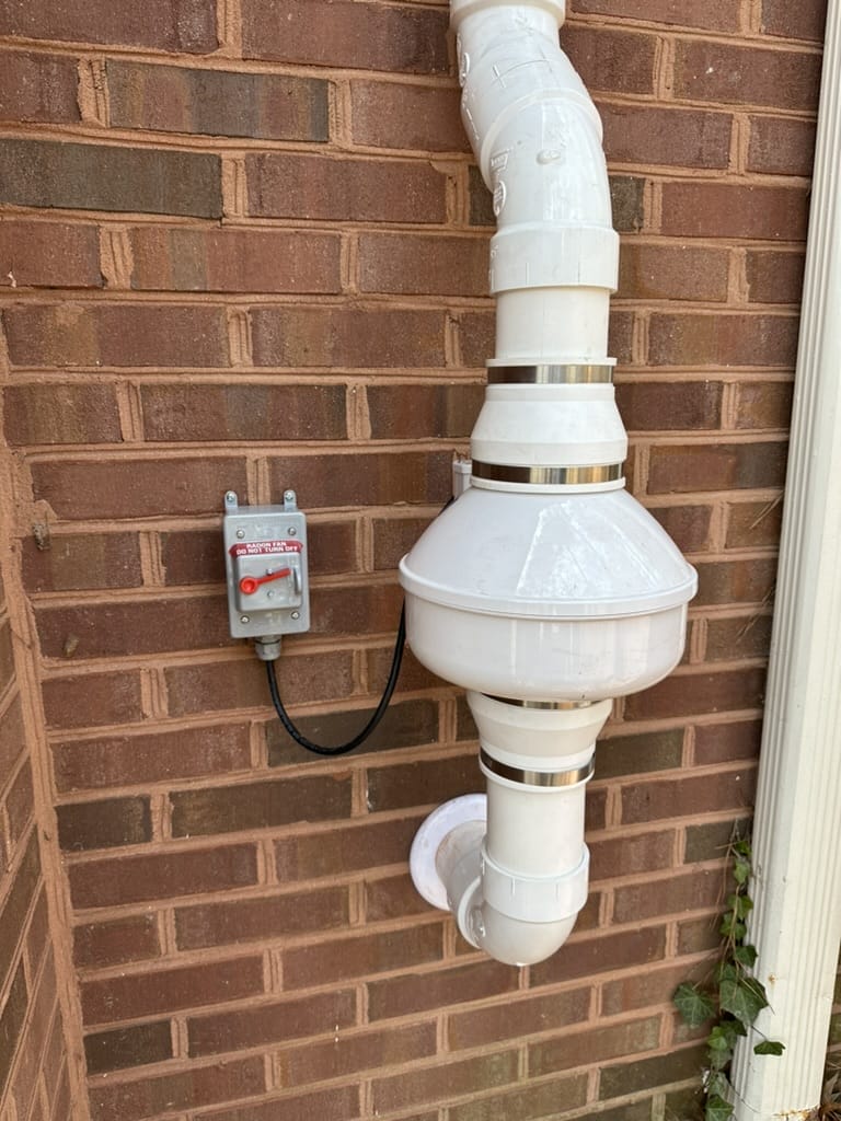 Radon Mitigation System On Home Exterior
